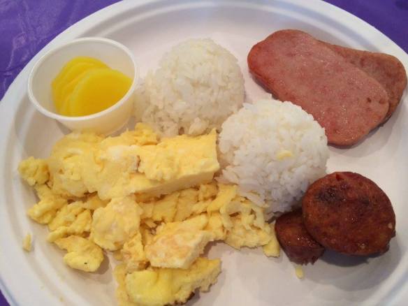 The goods . . . portuguese sausage, scrambled eggs, Spam, rice, and a cup of sliced takuan (pickled daikon radish).